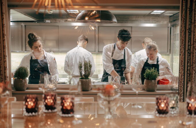 A shot of the kitchen at Restaurant Haerlin*** whilst several chefs are at work.