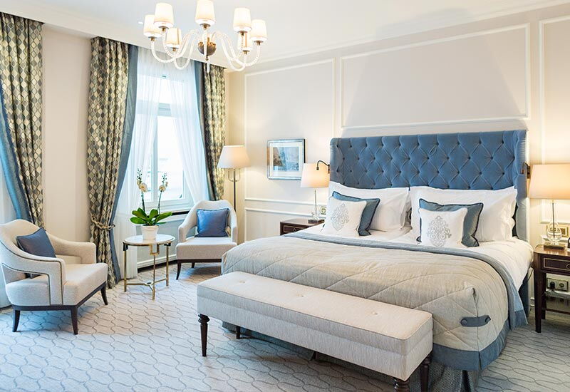 Der blau eingerichtete Schlafbereich im Doppelzimmer Alster Deluxe im Hotel Vier Jahreszeiten in Hamburg