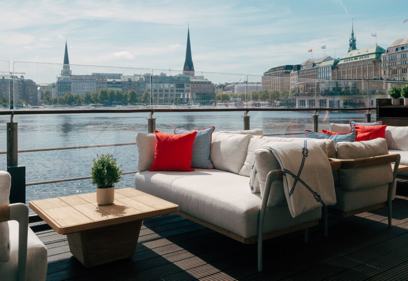 View of the upholstered seating in front of the view of the Alster and Hamburg