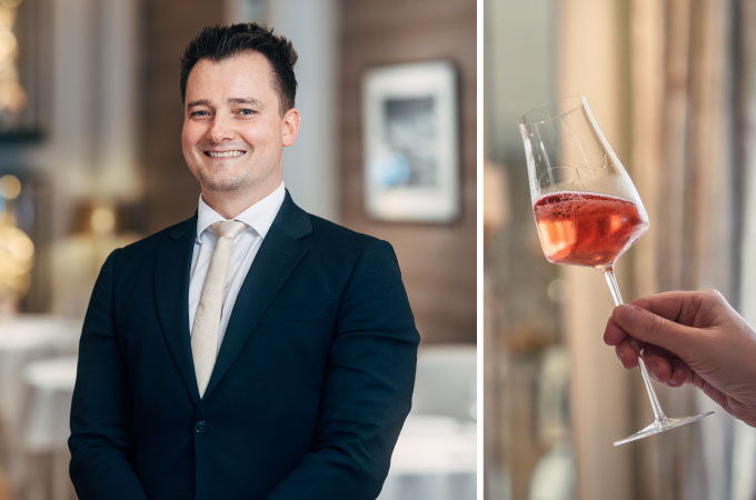 A portrait of sommelier Christian Scholz with a glass beside him.